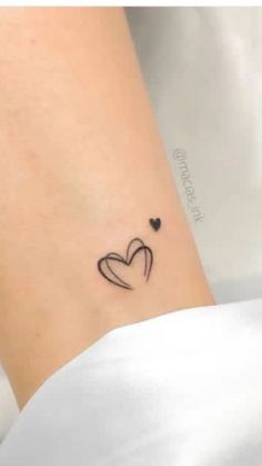 a small heart tattoo on the right side of the ankle, with two hearts in it