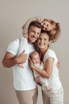 a man, woman and child are posing for a photo with their arms around each other