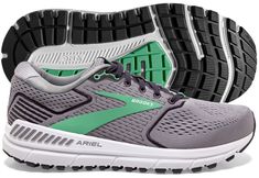 a pair of running shoes with green and white soles