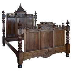 an antique wooden bed frame with intricate carvings