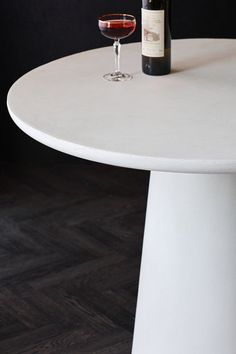 a bottle of wine sitting on top of a white table