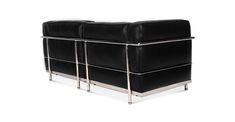 a black leather couch sitting on top of a metal frame