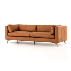 a tan leather couch with wooden legs on a white background