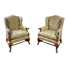 two chairs with floral upholstered back and arms