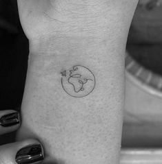 a woman's wrist with a small tattoo design on the left side of her arm