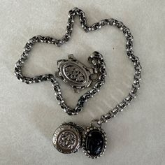 Excellent antique condition! Such a unique piece, dates to around the early Victorian Romantic period of 1840. Possibly a mourning guard chain or chatelaine belt as the cameo is carved from what is either jet, onyx, or a combination of both. Each end ornament has a set of two hook teeth to be affixed to the wearer's shoulders or waist. Unsure of full metal content, piece is non-magnetic except for two small components used in the swivel function of the hooks. Based on the time period, it is likely a silver alloy. Features hammered repousse charms including the black cameo, coat of arms, and a round seal of some sort. Measurements: Chain length 16.5 in / 42 cm Shield length 1.38 in / 4 cm Size: Womens OS Condition: Pre-Owned  Tags: true antique Victorian Oxidized Metal Jewelry, Victorian Jewelry With Oxidized Metal Finish, Silver Metal Cameo Jewelry, Silver Gothic Cameo Jewelry, Silver Cameo Metal Necklace, Silver Metal Cameo Necklace, Victorian Jewelry With Oxidized Finish, Collectible, Victorian Cameo Metal Jewelry, Victorian Metal Medallion Jewelry