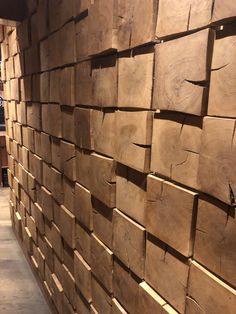 a wall made out of wooden planks in a store or office area with wood flooring