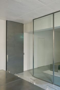 an empty room with mirrored walls and doors