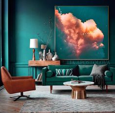 a living room with teal walls and art on the wall, two brown chairs in front of a green couch