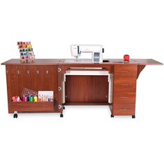 a sewing machine sitting on top of a wooden desk next to a cabinet with drawers