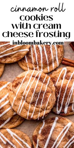 cinnamon roll cookies with cream cheese frosting are on a baking sheet and next to cinnamon sticks