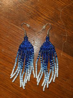 Native American style fringe earrings made with seed beads. Approx. 3.75" from piercing to bottom of jewelry. Gradient from cobalt to white. Sold as a pair. Blue Fringe Beaded Drop Earrings, Blue Fringed Beaded Drop Earrings, Adjustable Blue Beaded Fringe Earrings, Blue Fringe Dangle Chandelier Earrings, Blue Fringe Beaded Earrings, Blue Beaded Fringe Earrings, Native American Fashion, Beaded Fringe, Fringe Earrings