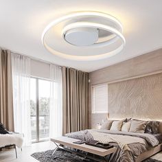 a bedroom with a large bed and a ceiling light