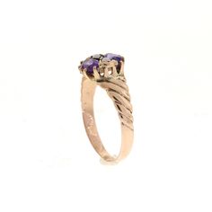 This lovely edwardian era ring features two vibrant purple oval amethysts. They measure about 5x3mm and are set horizontally. Between the two gemstones are two delicate seed pearls. The ring is a beautiful rosey gold. probably 12-14k. Hand engraved detail on each side add uniqueness to this vintage ring. It is perfect for a February birthstone ring. Size: 5.25 - Sizing smaller and larger up to two sizes is included. For larger sizes please inquire. Please see the Additional Policies section for Antique Oval Three Stone Rings, Vintage Oval Amethyst Birthstone Ring, Heirloom Purple Ring With Rose Cut Diamonds, Victorian Oval Amethyst Ring For Anniversary, Victorian Amethyst Ring For Anniversary, Victorian Style Oval Purple Amethyst Ring, Victorian Style Purple Amethyst Ring For Anniversary, Amethyst Ring With Rose Cut Diamonds, Oval Shape, Victorian Style Purple Oval Amethyst Ring