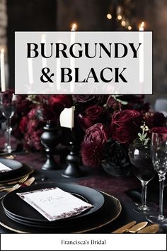 a black and white table setting with burgundy flowers