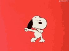 a red book with a cartoon dog holding a bone in it's mouth and the title, peanuts