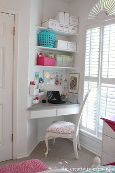 a white desk with a laptop on top of it in a bedroom next to a window