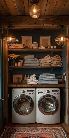 a washer and dryer in a room with wooden shelves on the wall above them