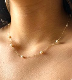 Classic and dainty freshwater and gold necklace. - 5x4mm Rice freshwater Pearl beads. - 14k Gold filled chain - 14k Gold filled closure. Adjustable 2 inches extender chain. * Custom orders welcome. Freshwater pearls are cultured pearls, grown in lakes, rivers, as well as ponds. Most Freshwater pearls are white and resemble Akoya pearls, but they also produce a variety of pastel shades, including pink, lilac and peach. Every once in awhile, you see things that bring you pure joy. Admire this neck Dainty Pearl Necklace With Round Beads, Dainty Single Strand Pearl Necklace In 14k Gold, Delicate Tiny Beads Pearl Necklace For Wedding, Delicate Pearl Necklace With Tiny Beads For Wedding, Dainty 14k Gold-filled Single Strand Pearl Necklace, Delicate Pearl Necklace With Tiny Beads, Dainty Pearl Necklace With Pearl Chain, Dainty Pearl White Pearl Necklace, Dainty Yellow Gold Pearl Necklace