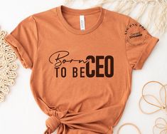 a t - shirt with the words born to be eco printed on it next to other items