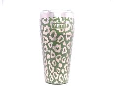 a green and white leopard print tumbler cup with the word yet written on it