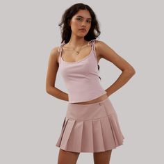 Indulge in the sophisticated style of our Preppy Hottie Pleated Skirt. Its elegant pleats and luxurious fabric create a tastefully exclusive look. Perfect for any occasion, this skirt is a must-have for any fashion lover. Elevate your wardrobe with this premium piece. Features: -85% Polyester -Low Waist -Solid Color -Pleated Design -Regular fit -Preppy style Pleated Flared Mini Skirt In Feminine Style, Chic Fitted Tiered Tennis Skirt, Chic Pink Pleated Tennis Skirt, Elegant Flared Tennis Skirt For Summer, Elegant Fitted Tennis Skirt For Spring, Feminine Fitted Mini Skirt With Gathered Details, Fitted Feminine Gathered Mini Skirt, Elegant Flowy Tennis Skirt For Summer, Elegant Spring Tennis Skirt