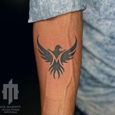 a man's arm with a tattoo on it that has a bird on it