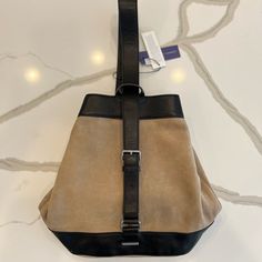 Nwt Rebecca Minkoff Suede Leather Mission Sling Backpack With Leather Trim. Elevate Your Casual Style With This Mission Sling Backpack. Beige Suede Leather Bag With Black Leather Trim And Silver Tone Hardware. Leather Adjustable Shoulder Strap. Signature Logo Hardware And Studs. Nylon Lined Interior Features A Large Clip Closure An Interior Zipper Pocket And Dual Slip Pockets. Designer Leather Shoulder Backpack, Designer Shoulder Bag Standard Backpack For Everyday Use, Designer Shoulder Bag As Standard Backpack For Everyday Use, Designer Backpack For Everyday Use, Designer Leather Backpack Satchel, Leather Bucket Bag With Leather Trim For On-the-go, Designer Brown Backpack For Everyday, Luxury Leather Trim Backpack Shoulder Bag, Luxury Leather Trim Shoulder Backpack