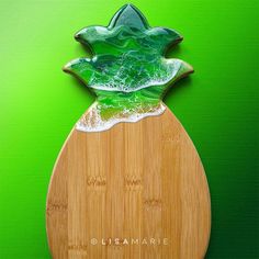 a green glass pineapple on top of a wooden board