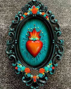 an ornate frame with a heart painted on it