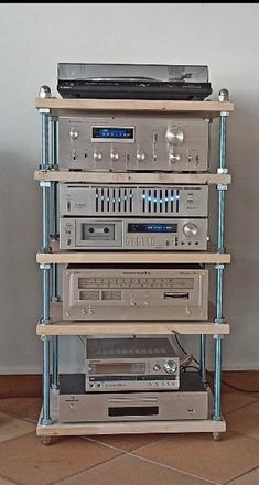 a stack of stereo equipment sitting on top of each other in front of a wall