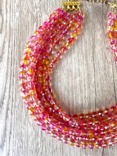 A gorgeous beaded statement necklace made with pink and orange faceted crystal beads. - 6 strands (more are listed)- Shortest strand measures 18.75 - 20.75" (will vary depending on clasp)- Gold stainless steel lobster claw (sterling silver, gold filled, stainless steel are also available) - 2" gold stainless steel extender chain- Lead free pewter multi strand connectorThe necklace length can also be customized. The mannequin's neck size is 14.5" for your reference. .A matching bracelet and earri Crystal Statement Necklace, Orange Crystals, Beaded Statement Necklace, Matching Bracelet, Multi Strand Necklace, Glass Bead Necklace, Faceted Crystal, Matching Bracelets, Pink Crystal