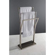 a towel rack with two white towels hanging on it's sides and a metal holder