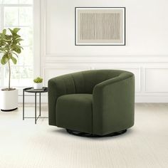 a living room with a green chair and table next to a potted plant in the corner