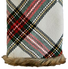 a white and green plaid pillow on top of a fur trimming cone with a brown fringe