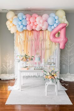 a table with balloons and cake on it