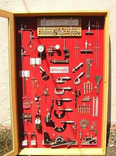 a red display case filled with lots of different types of tools and gadgets