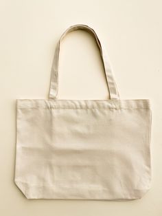 "Our Minimalist Wide Tote makes for the summer beach bag. To increase the functionality, we added interior pockets so you can keep your small items right where you want them.  -Can hold up to 34 lbs -Hand painted in the US -Interior pockets, magnet closure -Size: 18\" width by 13\" height -Strap length: 23" Simple Cream Bag For Everyday Use, Beige Reusable Bags For Daily Use, Minimalist Cream Travel Bag, Practical Everyday Reusable Bags, Minimalist Bags With Flat Pocket For Everyday Use, Minimalist Bags For Everyday Use With Flat Pocket, Beige Travel Bags With Flat Pocket, Minimalist Everyday Bag With Flat Pocket, Minimalist Everyday Bags With Flat Pocket