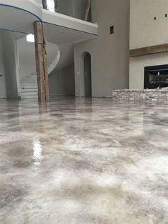 an empty room with white walls and flooring in the process of being remodeled by professional painters