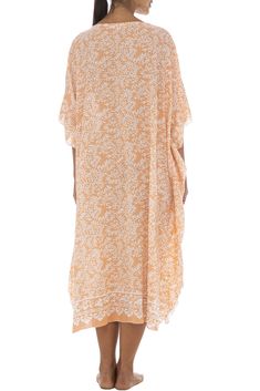 Soft as a daydream, this flowing poncho style black dress sweetens your summer downtime with its light flowing fabric and pastel buttermint hues. Handmade design features a pretty batik floral print, as well as butterfly sleeves that mirror the easy mid-calf hemline. Generously sized to provide ample coverage for womens regular to plus sizes; wear as a beach caftan, lounge dress or maxi cover up for swimwear. Back From Bali is dedicated to creating beautiful, quality clothing with a heart. All o Orange Spring Kaftan With Kimono Sleeves, Orange Kaftan With Kimono Sleeves For Spring, Spring Kaftan With Kimono Sleeves And Relaxed Fit, Spring Beach Cover-up Breezy Kaftan, Oversized Summer Dress With Kimono Sleeves, Flowy Half Sleeve Beach Dress, Casual Half Sleeve Maxi Dress For Beach, Casual Half-sleeve Maxi Dress For Beach, Oversized Dress With Kimono Sleeves For Summer