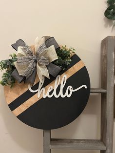 These wooden door hangers add the perfect touch of farmhouse style that can be kept up all year round. This door hanger is a beautiful piece to add to your decor and they make a perfect housewarming gift, realtor gift, wedding gift, birthday gift and more.  Details: - 18" diameter - Front & Back are stained for a finished look  - 1" felt pads attached to back to provide protection against door/wall - Hand painted & sealed for protection  - Finished with a decorative bow and greenery - Comes ready to hang as soon as it arrives at your doorstep!  Shipping details: - Most orders are shipped via USPS Priority - All signs are made to order, so be sure to check processing & shipping times before ordering!  Care: Our signs are sealed for protection from the elements, making them perfect for indoo Grey Welcome Sign Front Door, Hello Welcome Sign, Hello Round Wood Sign, Welcome Round Sign Front Door, Hello Door Sign, Hello Door Hanger, Round Welcome Door Signs, Welcome Door Hangers, Boho Door Hanger