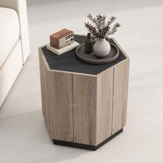 a small table with a vase and some books on it