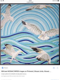 three white birds flying over the ocean on blue and green mosaic tiles with waves in the background