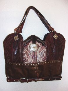 Experience the world of western sophistication with the versatile, roomy and rustic Extra Large Cowboy Boot tote. Ecofriendly, made with recycled boots and belts. Features luxurious western accents and top-quality hardware. Tote-style with spacious measuring up to 14"x20-22" Handmade, numbered and signed for exclusivity. No two alike. Unique travel, laptop or diaper bag. This versatile tote is your trusty sidekick, ready to carry you from the office to the open road. Crafted from upcycled cowboy Brown Leather Bags For Rodeo, Western Style Brown Bags For Rodeo, Western Style Brown Bag With Concho, Western Leather Bags For Rodeo, Western Brown Bags For Rodeo, Western Style Rectangular Travel Bag, Cowboy Boot Wallet, Western Leather Bags With Concho Details, Totes Boots