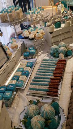 desserts and cupcakes are displayed on a table