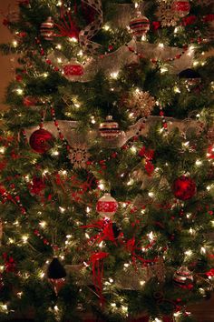 a decorated christmas tree with red and silver ornaments