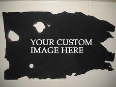 a sign that says your custom image here on the side of a wall with holes in it