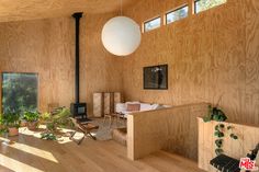 a living room with wood paneling and potted plants