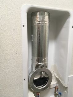 a stainless steel tank mounted to the side of a wall