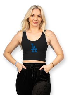 A much needed staple to rep your favorite team! Versatile enough to dress up or down, the logo crop tank is the everyday wardrobe staple for baseball fans! ✦ Black cropped tank✦ Royal blue MLB Dodgers logo ✦ Seamless, Ribbed, Cropped Tank Top ✦ 92% Nylon, 8% Spandex Collegiate Black Sleeveless Top, Sporty Logo Print Crop Top For Streetwear, Sporty Streetwear Tank Top With Logo Print, Sporty Tank Top With Logo Print For Streetwear, Black Sports Crop Top With Letter Print, Black Letter Print Crop Top For Sports, Black Athleisure Crop Top With Letter Print For Sports, Collegiate Sleeveless Top With Team Logo, Sleeveless Letter Print Crop Top For Sports